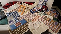 Overview of various colorful Canadian stamp sheets and booklets spread on a surface.