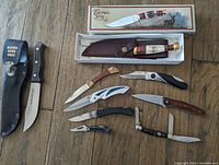 Photo of the full collection of fixed blade and folding knives including boxed stag handle knife and variety of pocket knives