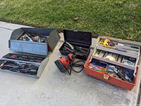 Overview of all three toolboxes and palm sander showing the variety of tools included in the lot