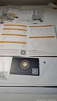 Grading report, authenticity card, and moissanite gemstone displayed