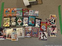 Visible variety of assorted vintage baseball card packs and loose cards laid on carpet showing multiple brands and pack types
