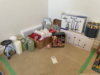 Wide view of the lot showing various candles and candle holders including boxed items and decorative storage box.