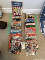 Overview of two taped-off stacks of comics on floor