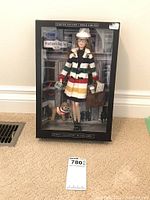 Front view of unopened boxed doll with Hudson’s Bay stripes and branding
