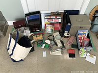 Wide view of entire lot showing office supplies, canvas bag, metal box, binders, crayons, glue tool and more