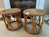 Pair of round rattan stools displayed side by side showing front and side views.