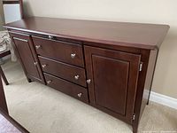 Front view showing two cabinets and three central drawers