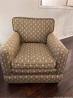 Front view of the armchair showing overall design and fabric pattern.