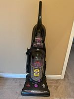Front view of Bissell Cleanview Helix Deluxe upright vacuum cleaner showing overall condition and power cord wrapped on the side.