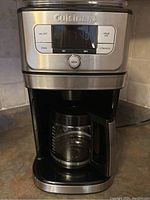 Front view of Cuisinart coffee maker showing digital display and glass carafe in place.
