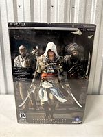 Front view of Assassin's Creed Black Flag Limited Edition box for PS3 with artwork of three game characters and seal intact.