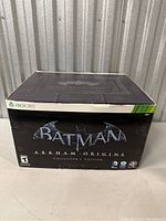 Closed Batman Arkham Origins Collector's Edition box with Xbox 360 branding and game logo on the front.