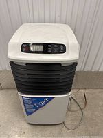 Front view of the Danby appliance showing control panel with display and buttons and black slats as vents along with the product label.