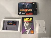 Full lot showing the SNES cartridge, the game box, the instruction manual, and a mailer card spread on a table.