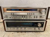 Front view stacked, both units powered on showing illuminated tuning scales