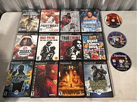 Overview of PlayStation 2 game titles included in the lot, showing cases and loose discs arranged on table.