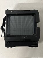 Rear view showing ground glass focusing screen with grid and surrounding body edges.
