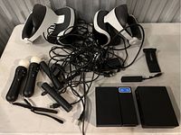 Lot overview: two headsets, two Move controllers, charging stands, processor unit, cables