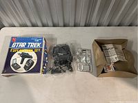 Full view of the box, plastic model kit parts in bags, and instruction manual inside the original packaging.