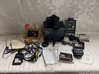 Panoramic view of the entire camera bundle laid out on a white surface against patterned wallpaper background