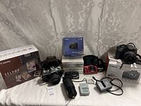 Lot overview with printer box, film camera, lenses, chargers and cameras