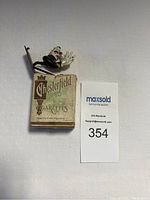 Front view of a vintage Chesterfield cigarette box with a colorful clown figurine attached to the top.