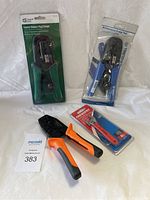 Four crimping and cutting tools displayed on white background. Included are commercial electric ratchet modular plug crimper, truper professional crimp tool, crescent diagonal cutters, and wire stripper tools.