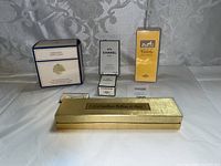 Group shot of six sealed perfume and powder items on white background