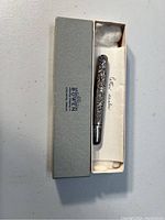 Antique Bowen sterling silver letter sealer in original branded box, showing intricate floral engravings on metal.