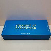 Blue rectangular box with gold text 'Straight Up Perfection' and 'Philosophy of Hair' by PYT