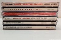 Stack of 6 Christmas CD cases showing album titles on case spines