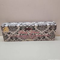 Decorative box packaging of Pink Zebra hair straightener showing overall design and branding.