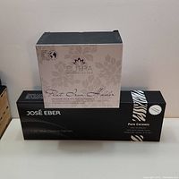 Photo showing José Eber flat iron box and Sutra flat iron holder box stacked on each other.