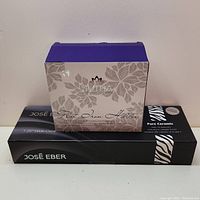 Front view of José Eber flat iron box with Sutra Organic flat iron holder box on top
