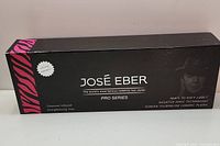 Full frontal view of the black packaging box showing Jos Eber branding, product description and features of the straightening iron.