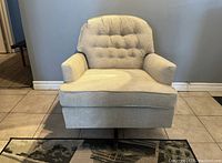 Front view of the newly upholstered vintage Kroehler swivel rocker chair showing tufted button back and cushioned seat