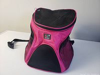 Front view of pink animal carrier backpack with mesh ventilation and adjustable straps
