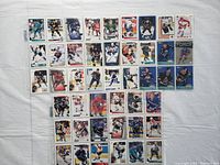 Overview of 45 hockey cards arranged in rows inside plastic sleeves on a white background.