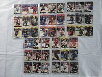 Front view of 45 hockey cards in 5 rows on a light surface, featuring players in various team uniforms.