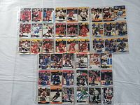 Front side view of 45 hockey cards arranged in rows inside plastic protective sheets.