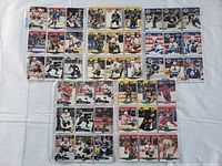 Array of 45 hockey cards laid out in plastic files showing front player images and team logos from 1990-1992 seasons.