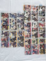 Top view of 45 hockey cards arranged in plastic sleeves showing various players in uniform from 1990-1992