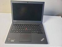 Open laptop showing Lenovo ThinkPad keyboard and screen.