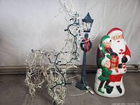 Unlit view of reindeer, lamppost, and Santa blow mold