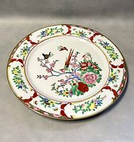 Top view of the full decorative porcelain plate showing the entire hand-painted design and border