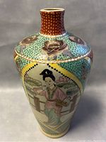 Front view showing the full hand painted female figure and embossed floral decorations on the vase.