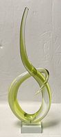 Front view of green and clear twisted Murano Sommerso glass sculpture with square glass base.