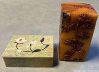 Photo showing the marble trinket box with mother of pearl floral inlay next to the carved Shoushan seal stamp.