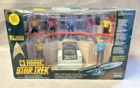 Wide shot of the full packaged Star Trek Classic Collector Figure Set showing all seven figures and a captain's chair replica