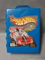 Blue plastic Hot Wheels storage carrying case with red race car graphic and Hot Wheels logo